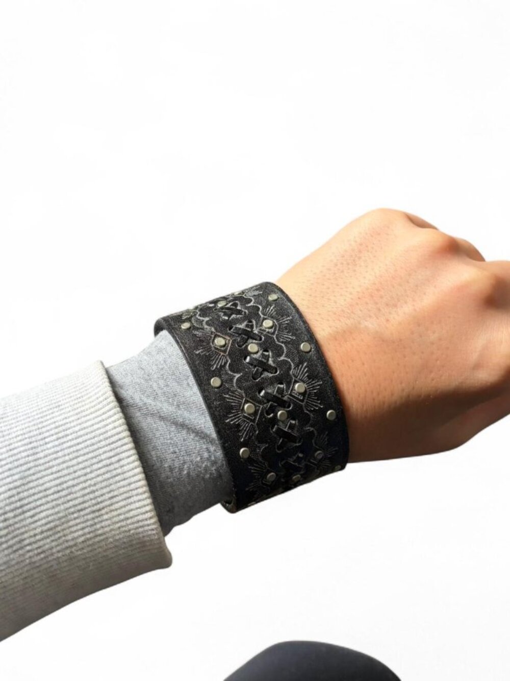 Black leather cuff bracelet with silver studs and embossed geometric design